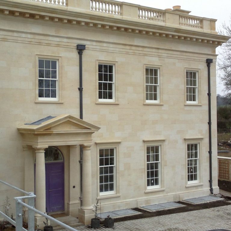 Tuscan order portico with pediment