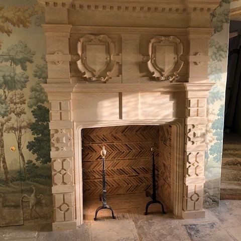 Cotswold stone baronial chimneypiece with carved overmantel